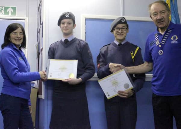 Adur East Lions president Jim Pummell and member Susan Saunders present certificates to air cadets Daniel Porter and Stacey Harrington