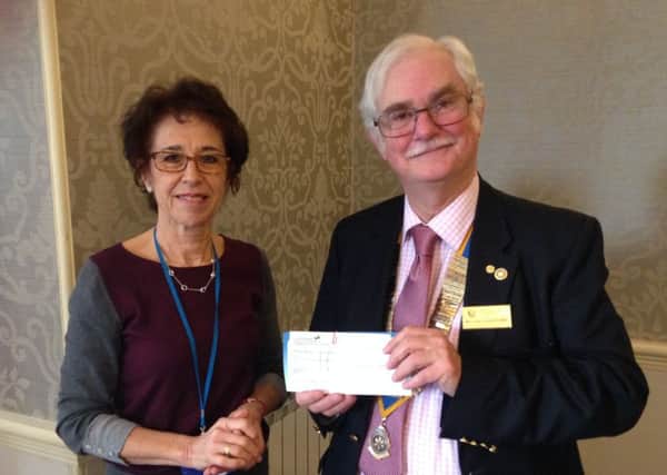 Battle Rotary Club president Michael Hodge receives the cheque from St Michael's Hospice's Marcia Dart