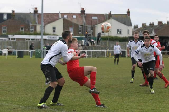 Horsham YMCA's Phil Johnson (red) in action. Photo by Clive Turner