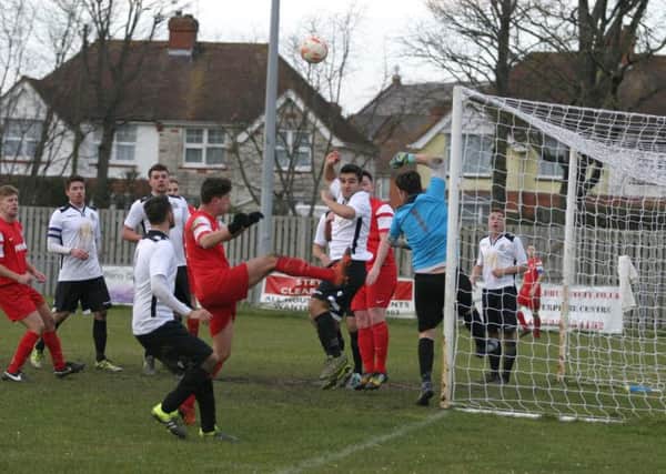 YM`s Luke Donaldson (red) in Eastbourne Utd AFC goalmouth action from a YM corner. Photo by Clive Turner