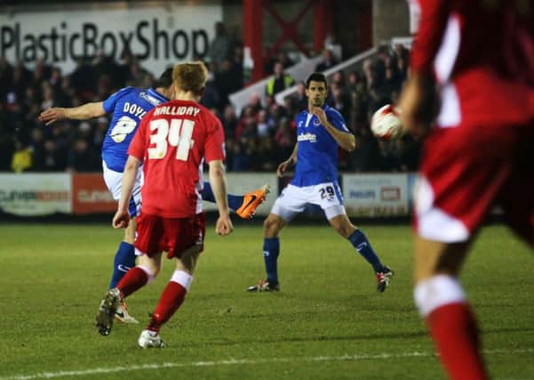 Skipper Michael Doyle volleys home Pompey's third goal at Accrington. Picture: Joe Pepler