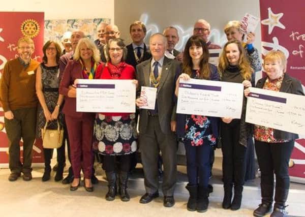 Rotarians present cheques to local charities SUS-160903-105310001
