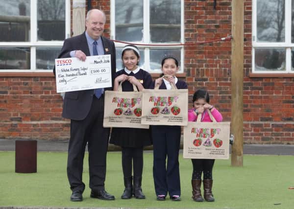 Steve Davis with winner Tasneem Malique, and sisters Tanjina and Liyanna. Tasneem won a competition to create a bag dsign for Tesco at Shoreham.