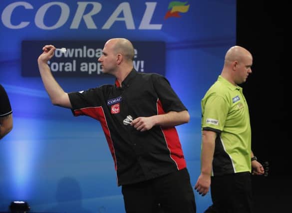 Rob Cross in action against Michael van Gerwen. Picture courtesy Lawrence Lustig/PDC