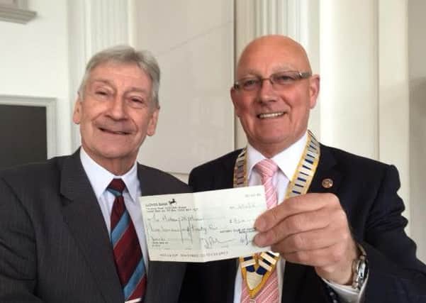 Rotary club president Nigel Greaves presents the club's cheque to Matthew 25 administrator, Graham Horsnell. SUS-161003-153231001