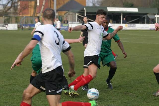 YM`s Alex Gathern (white right) clears away an attempt by Pagham. Photo by Clive Turner.jpg SUS-160315-103156002