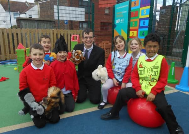 Cllr Holt with Bourne School children and their new play equipment SUS-160316-115716001