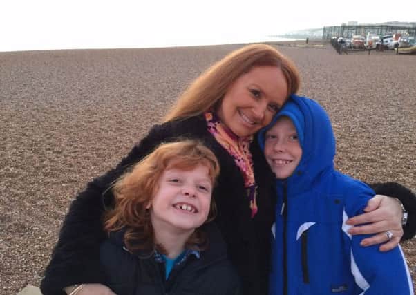 Jackie Mannell with her two sons on Hastings beach SUS-160322-154904001
