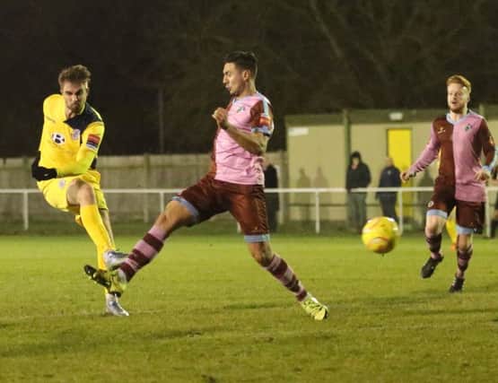 Zac Attwood (yellow kit) scores the second Hastings United goal in Tuesday night's 2-2 draw away to Corinthian-Casuals. Picture courtesy Scott White