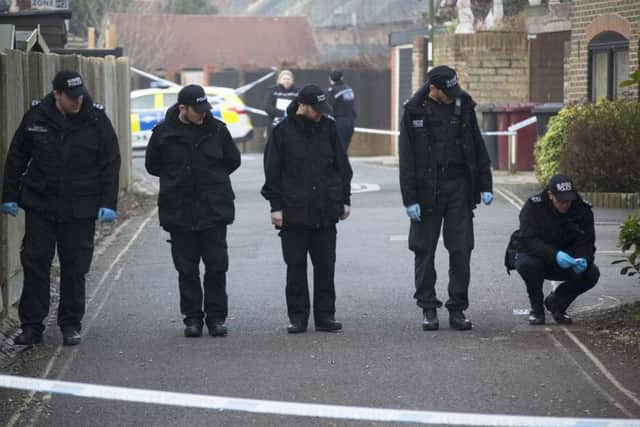 Police search the scene after fatal stabbing in Chichester.