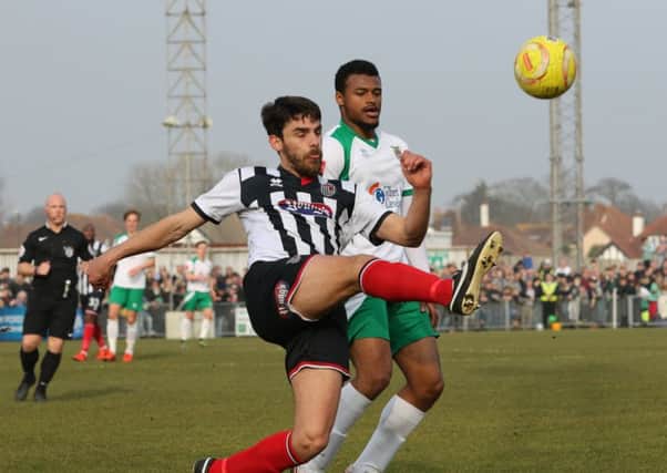 Chike Kandi battles for possession against Grimsby / Picture by Tim Hale