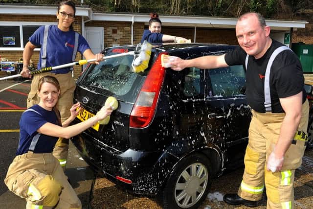 Charity car wash at Haywards Heath Fire Station was interupted by an emergency call out on Saturday.  Pic Steve Robards SR1608041 SUS-160314-121014001