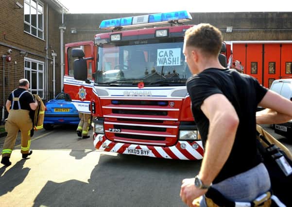 Charity car wash at Haywards Heath Fire Station was interupted by an emergency call out on Saturday.  Pic Steve Robards SR1608033 SUS-160314-121003001
