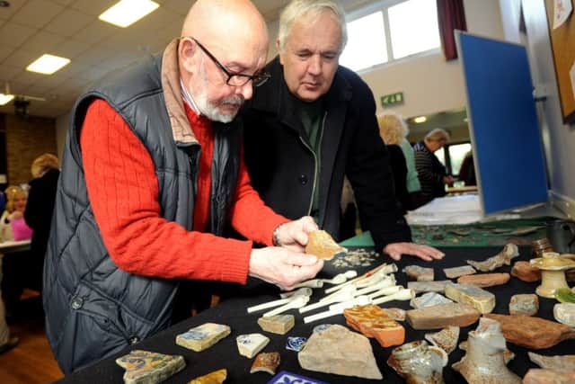 ks16000586-2 Lancing U3A Exhibit   phot kate
Archaeologist,  Edward Everett and visitor Robert Shute looking at some assorted finds.ks16000586-2 SUS-160703-192835008