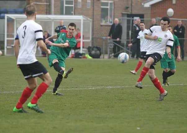 YM`s Alex Gathern (white right) clears away an attempt by Pagham. Photo by Clive Turner SUS-160315-103143002