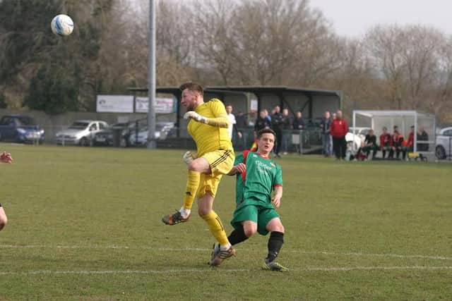 YM`s `keeper, Simon Lockwood heads clear a Pagham attempt and makes safe. Photo by Clive Turner SUS-160315-103218002