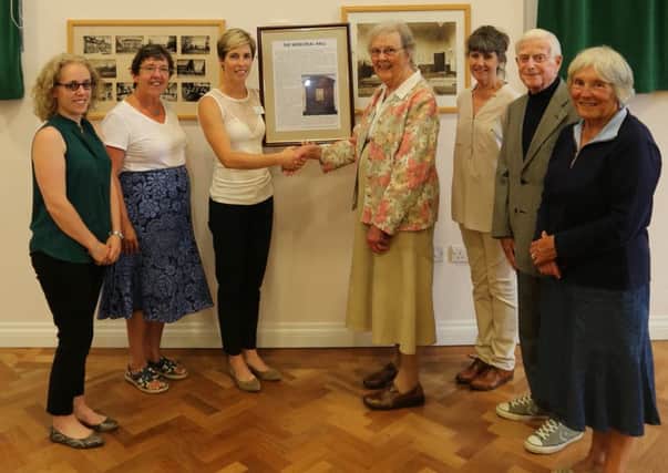 Henry Bond joins Sheila Ryan and other Midhurst Society members at a presentation ceremony in the Memorial Hall