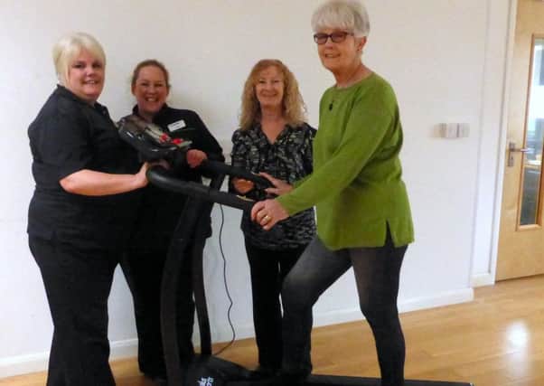 Left to right, store staff Paula White and Candice Moore with treatment centre manager Penny Peters, centre member Marion Castle and Paula Whites mother, Jill, on the new treadmill