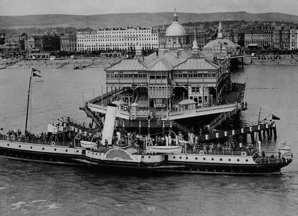 Yesteryear: A steamer docks at the end of Eastbourne Pier