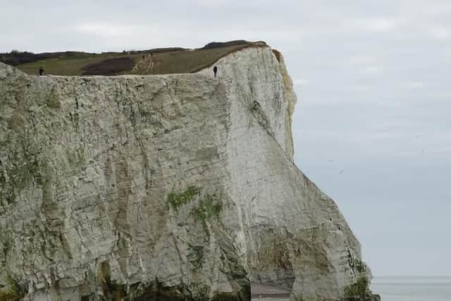Member of the public standing on the cliff edge at Seaford Head. Photo by Wayne Spring (Tweaky Blinders). SUS-160321-154312001