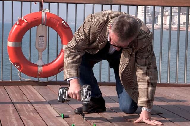 Suggs drilling the final screws into the Hastings Pier decking