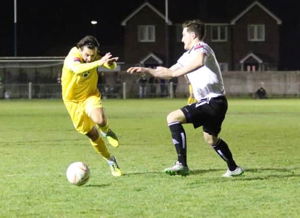Billy Medlock tries to take on a Molesey defender. Picture courtesy Scott White