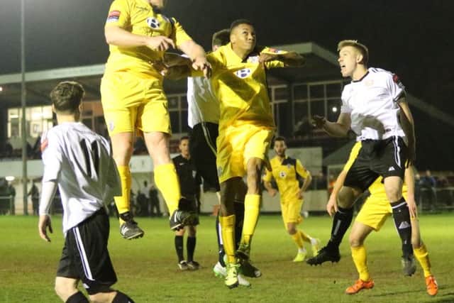 Hastings United defender Sean Ray gets his head to a cross into the Molesey box. Picture courtesy Scott White