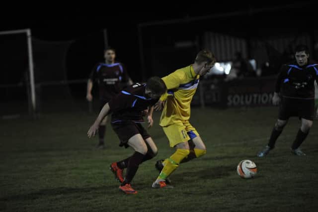 Langney Wanderers midfielder Paul Weatherby turns away from Little Common winger Dan Estherby. Picture by Simon Newstead (SUS-160323-101153002)