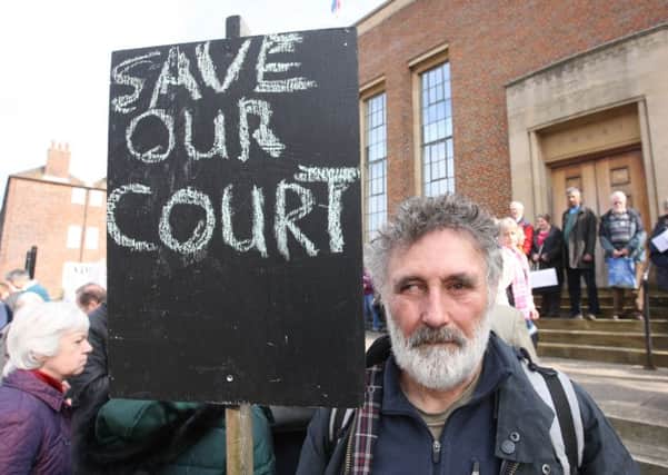 A man taking part in the recent public protest outside Chichester Crown Court. Photo by Derek Martin.