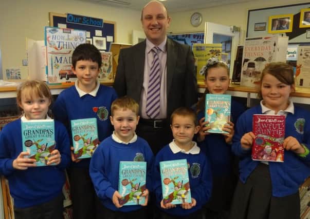 Julian Lee JML Law with the winning pupils from Billingshurst Primary School with their signed David Walliams books SUS-160704-130754001