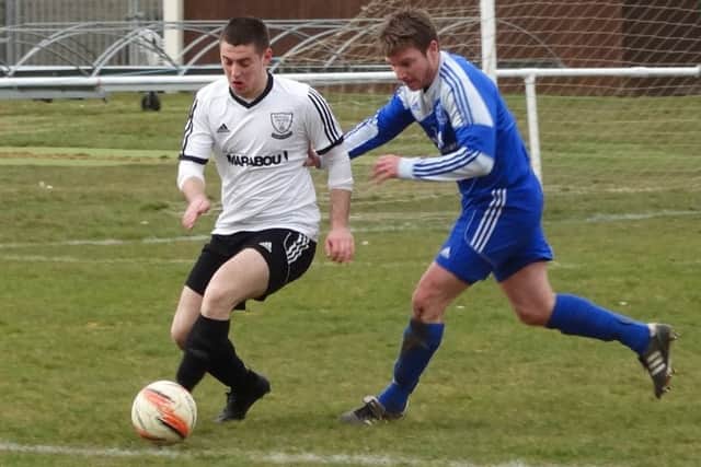 Bexhill United forward Jacob Shelton is shadowed by a Midhurst defender. Picture courtesy Mark Killy