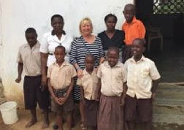 Christine Bayliss with Tabby Wamuhu Special Education Needs teacher and children at Mnarani Primary School, Mnarani Village in Kilifi County, Kenya. SUS-160329-154959001