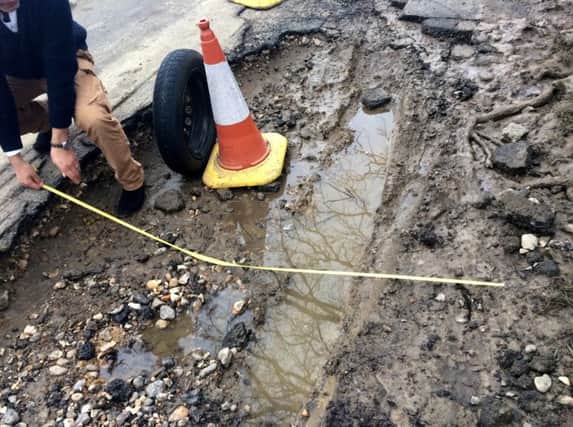 A massive pothole measuring 10ft long and more than a foot deep near Framfield, East Sussex. Photo by SWNS. SUS-160324-164723001