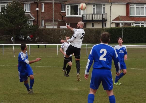 Bexhill United manager Marc Munday wins a header during last weekend's 1-0 defeat at home to Midhurst & Easebourne. Picture courtesy Mark Killy