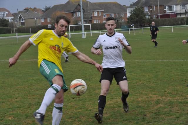 Bexhill United forward Kevin Barden closes down Sidlesham defender Paul Grantham. Picture by Simon Newstead (SUS-160326-214431002)