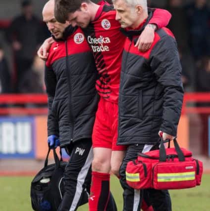Liam McAlinden gets taken off injured for Crawley Town against Exeter City, 28th March 2016. (c) Jack Beard SUS-160328-173832008