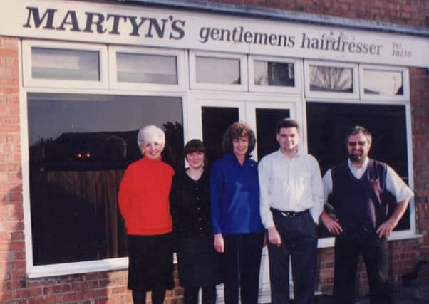 Martin (far right) outside the hairdressers with his staff in the 1980s