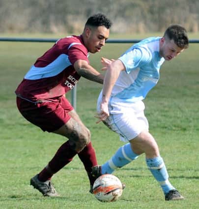Little Common defender Jerome Smith keeps a close eye on Bexhill United forward Kevin Barden. Picture courtesy Jon Smalldon