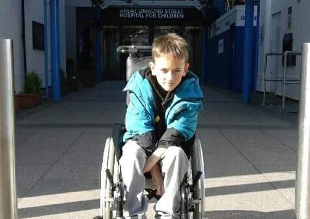 Toby Booker outside Great Ormond Street Hospital, where he will have his SDR operation on Friday