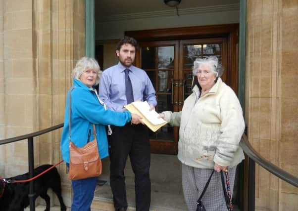 Bus campaigners Sally Pickthall and Pam Sheils  handing over their petition to West Sussex County Council