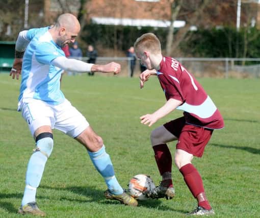 Bexhill United manager Marc Munday challenges Little Common midfielder Liam Foster. Picture courtesy Jon Smalldon