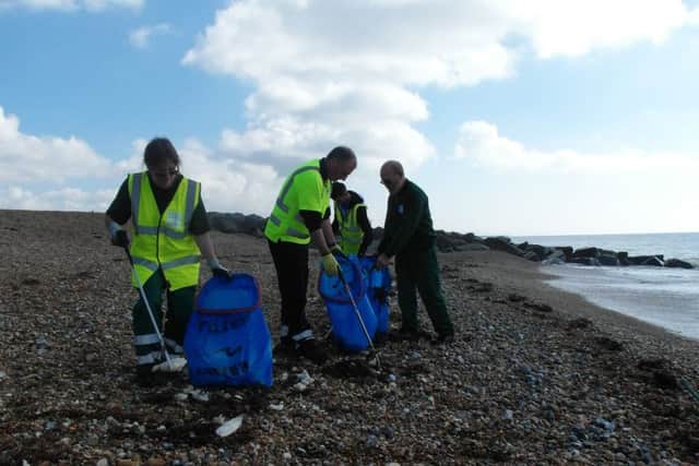 Adur and Worthing councils' park and foreshores team cleaning the coastline