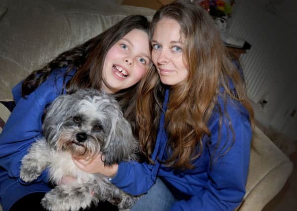 Katie Studley pictured with her nine-year-old daughter Pippa-Faith, and their dog Spartacus. SUS-160504-143826001