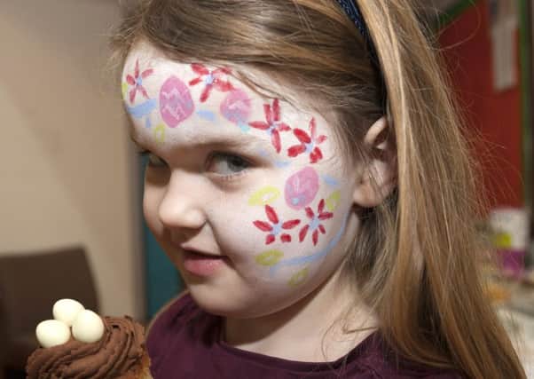Four-year-old Georgia was making the best of  the day with a face paint and delicious chocolate cupcake