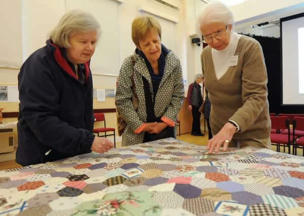 Sue Povey, Caroline Stoneman and exhibition steward, Annette Swann looking at a quilt at the exhibition