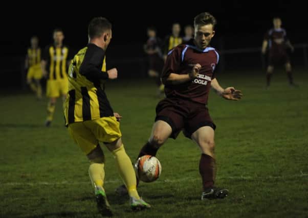 Little Common's 30-goal striker Jamie Crone challenges a Southwick opponent. Picture by Simon Newstead
