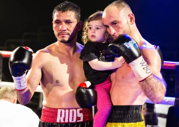 Rios shows great sportsmanship by posing with Jones and his daughter for photos, 9th April 2016. (c) Jack Beard SUS-160904-231758008