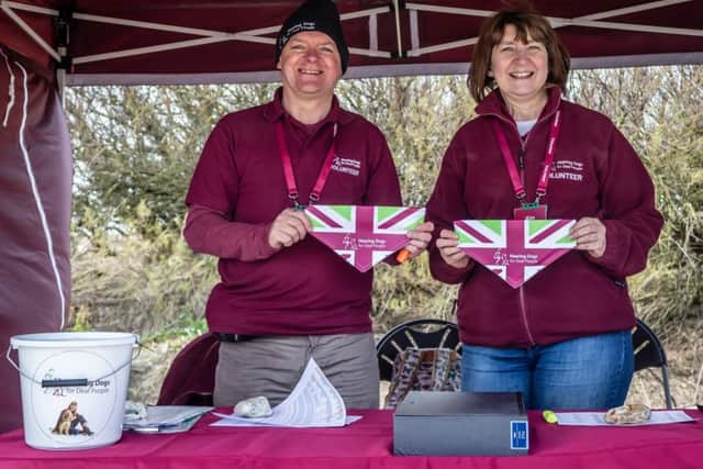 Volunteers hold up Great British Dog Walk bandanas
