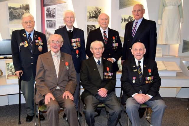 The six veterans who were presented with the Legion DHonneur, including Reginald Tim England, 93 (back, third from left)