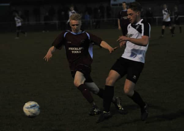Little Common midfielder Liam Foster closes down a Lancing opponent. Picture by Simon Newstead